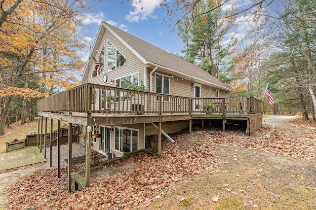 rear view of property featuring a deck