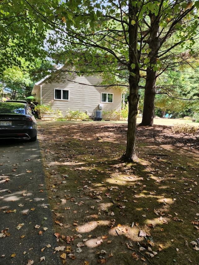 view of side of home with central air condition unit