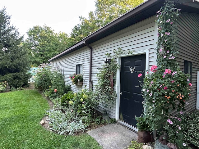 doorway to property with a yard