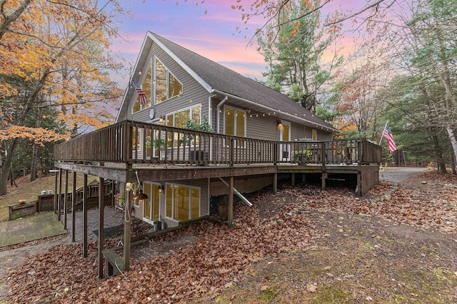 property exterior at dusk with a deck