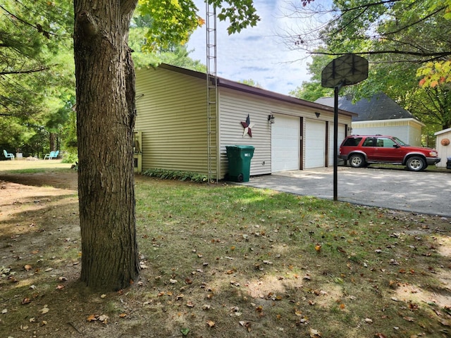 view of home's exterior featuring a lawn and a garage