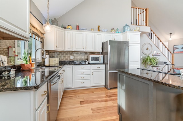 kitchen featuring white cabinets, stainless steel appliances, and sink