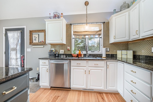 kitchen featuring decorative backsplash, white cabinets, dishwasher, light hardwood / wood-style floors, and sink