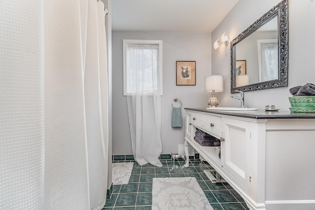 bathroom featuring vanity, curtained shower, and tile patterned floors