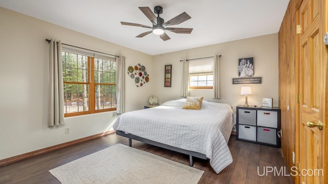 bedroom with dark hardwood / wood-style floors and ceiling fan