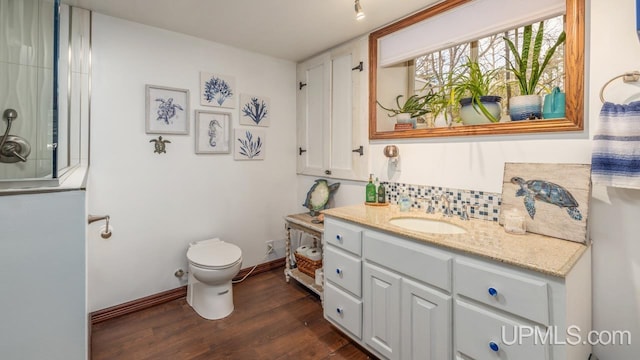 bathroom featuring hardwood / wood-style flooring, vanity, and toilet