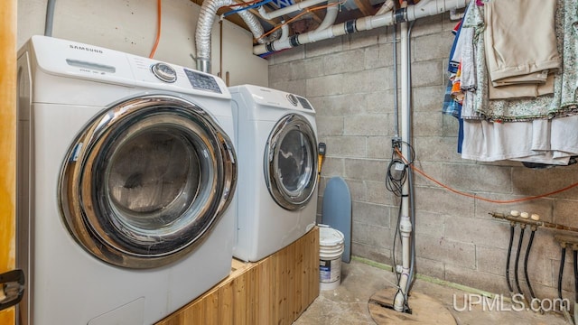 clothes washing area featuring separate washer and dryer