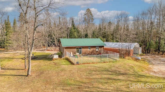 view of front of home with a front lawn and an outdoor structure