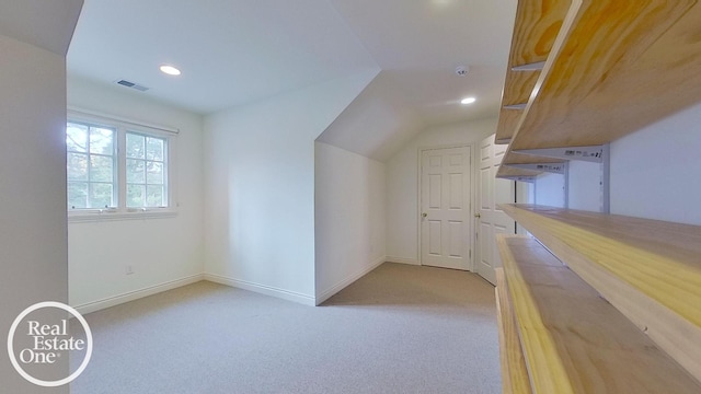 bonus room with light carpet and lofted ceiling