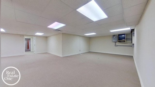 basement with carpet flooring and a drop ceiling