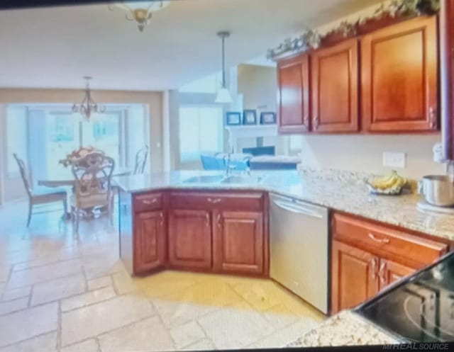 kitchen with kitchen peninsula, sink, a notable chandelier, pendant lighting, and stainless steel dishwasher