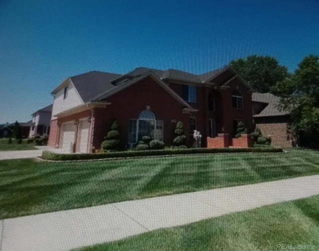 view of front facade with a front lawn and a garage