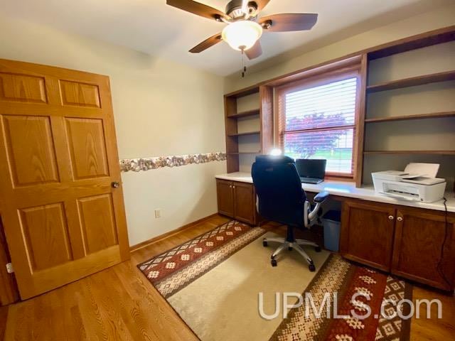 office area with light wood-type flooring and ceiling fan