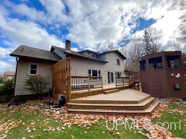 rear view of property featuring a deck