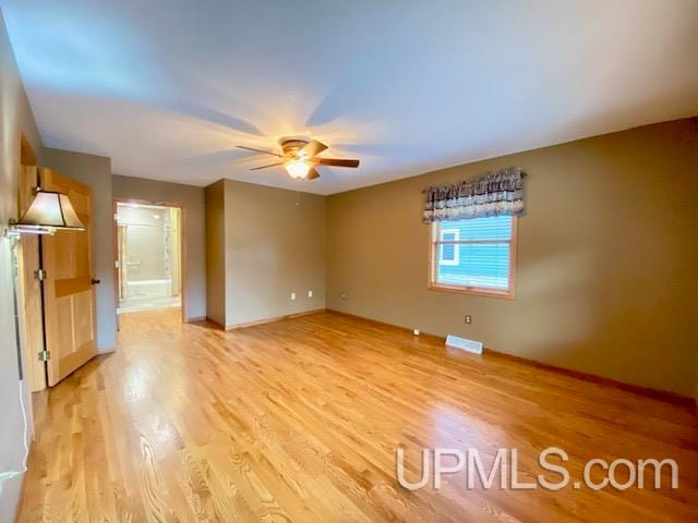 unfurnished room with ceiling fan and light hardwood / wood-style floors