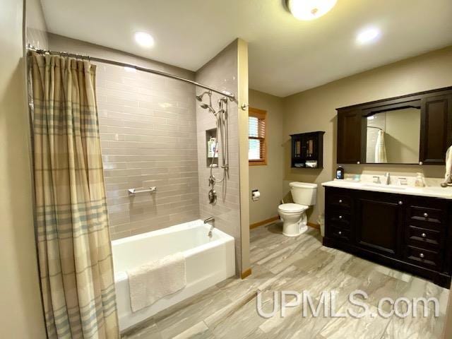 full bathroom featuring hardwood / wood-style floors, vanity, shower / bath combination with curtain, and toilet