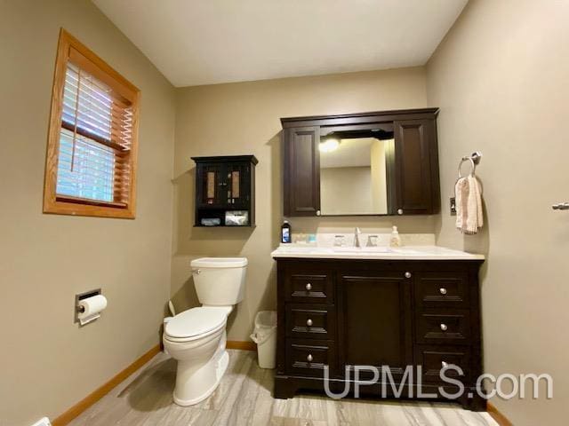 bathroom with vanity, toilet, and wood-type flooring