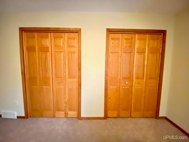 unfurnished bedroom with light colored carpet