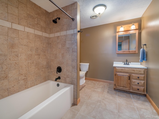 full bathroom with tile patterned floors, vanity, toilet, and a textured ceiling