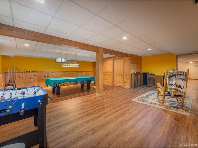 rec room with hardwood / wood-style floors, a paneled ceiling, wooden walls, and pool table