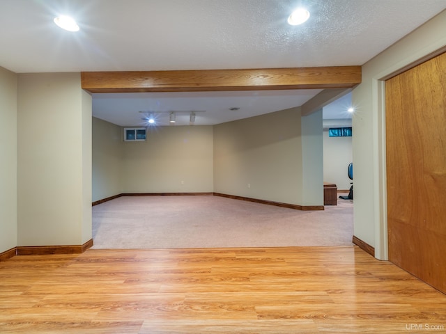 interior space with light hardwood / wood-style flooring and a textured ceiling