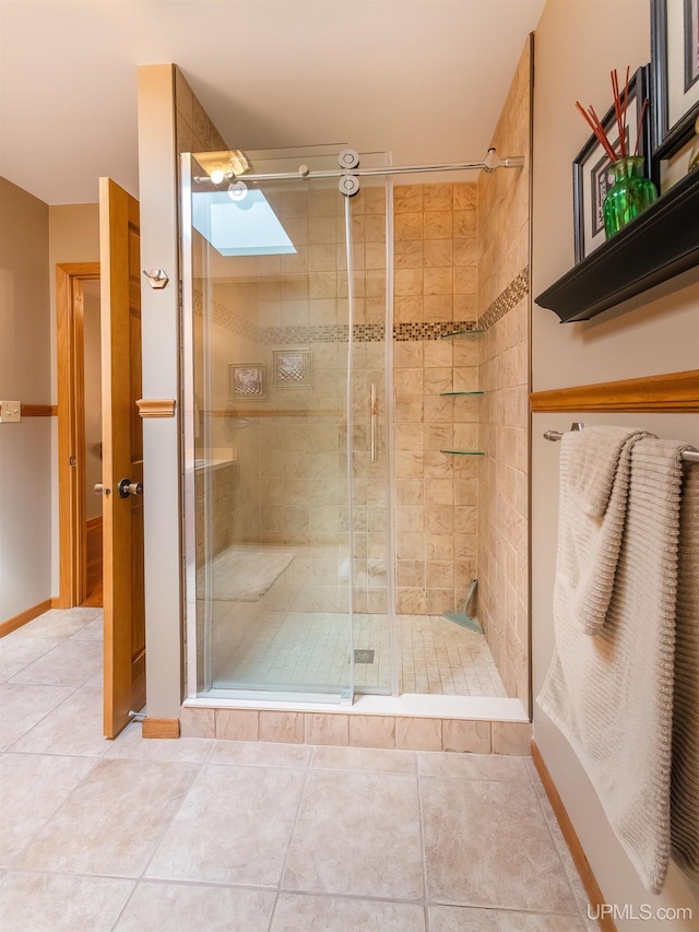 bathroom with tile patterned floors and walk in shower