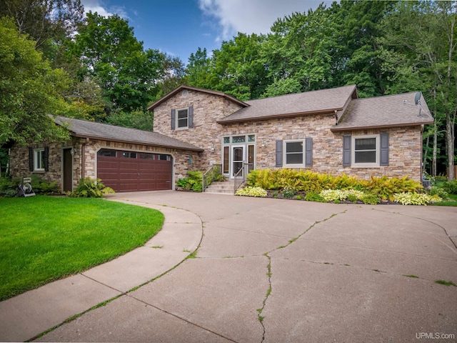 view of front of house with a garage and a front yard