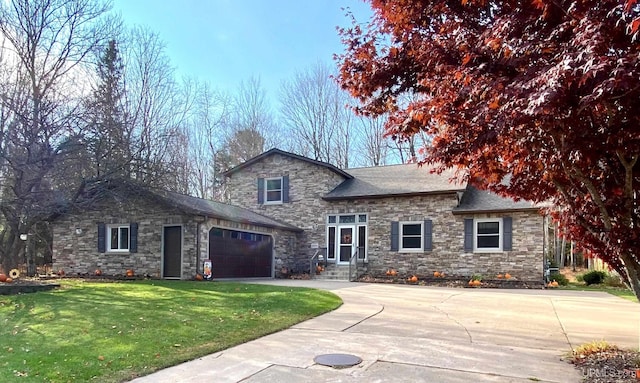 view of front of property with a front yard and a garage