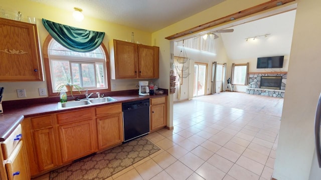 kitchen featuring black dishwasher, light tile patterned floors, sink, vaulted ceiling, and ceiling fan