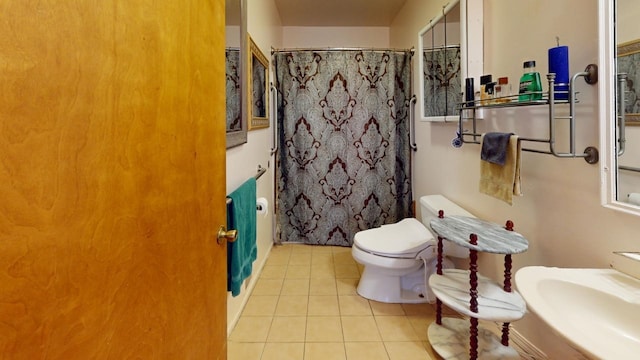 bathroom featuring walk in shower, tile patterned flooring, and toilet