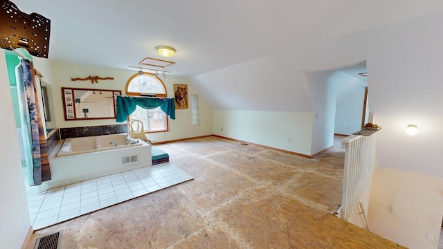 interior space with a bath and vaulted ceiling