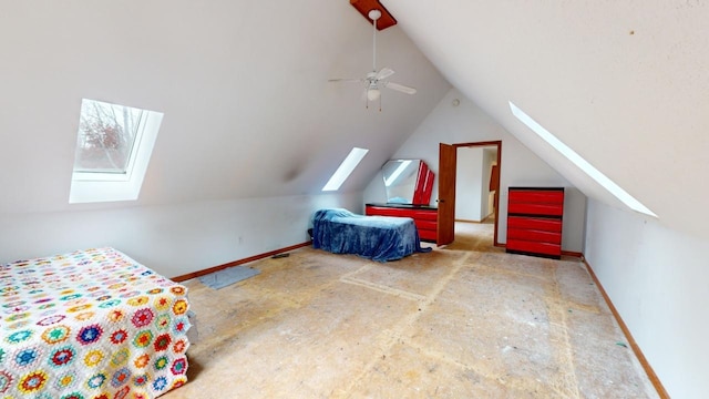 unfurnished bedroom featuring ceiling fan and vaulted ceiling with skylight