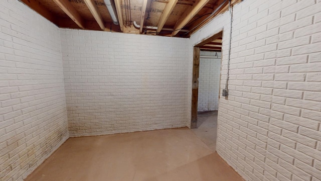 basement with brick wall