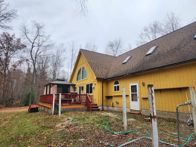 view of home's exterior featuring a wooden deck