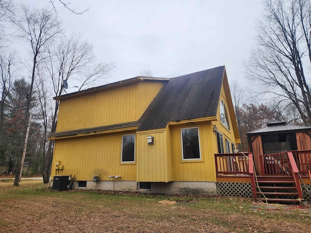 back of house featuring central AC unit, a gazebo, and a deck