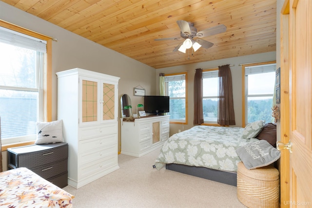 carpeted bedroom with ceiling fan and wood ceiling