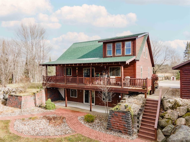 back of property featuring a patio and a wooden deck