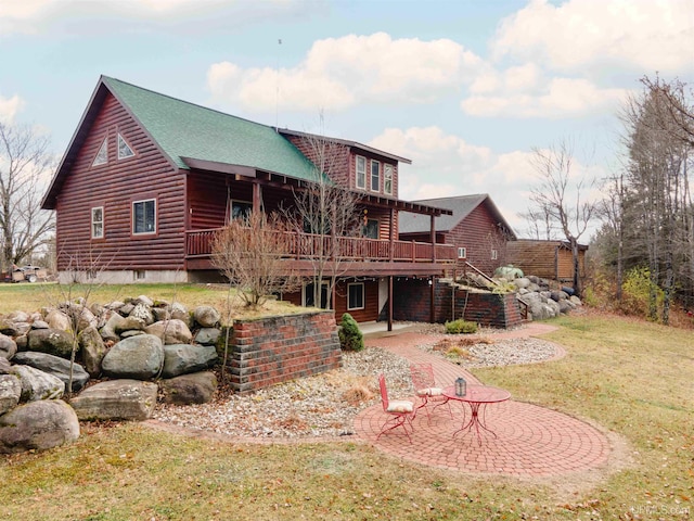 back of property with a yard, a patio, and a wooden deck