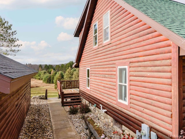 371 Morrison Creek Rd, Iron River, MI 49935 - view of property exterior with roof with shingles, a deck, and log veneer siding