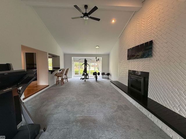 interior space featuring ceiling fan, brick wall, high vaulted ceiling, and carpet