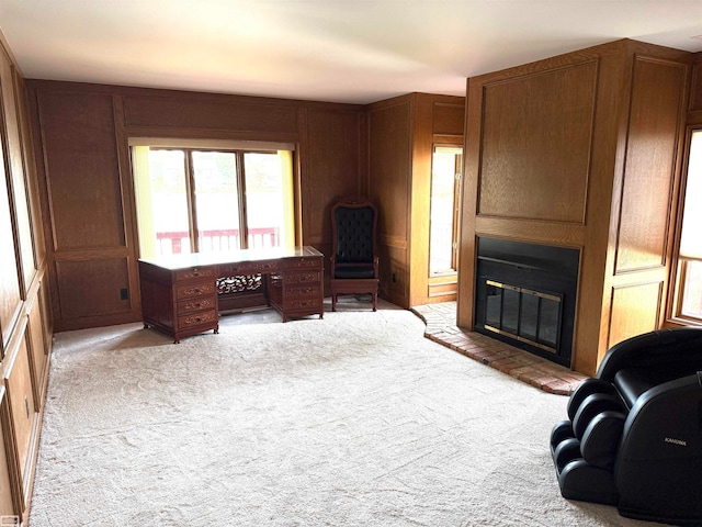 carpeted office featuring wood walls