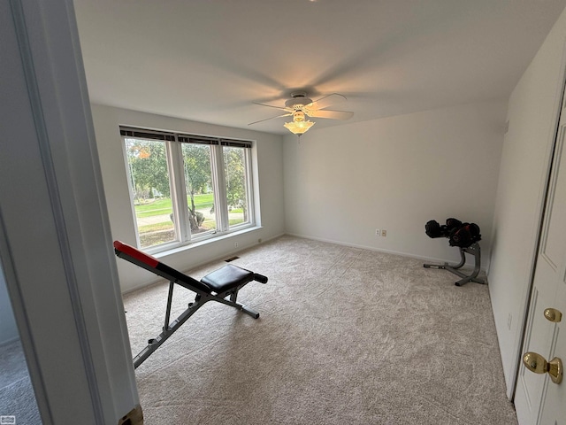 workout area featuring light colored carpet and ceiling fan