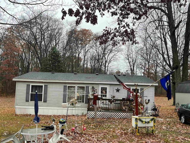 back of property with a wooden deck