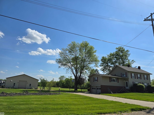 exterior space featuring a lawn and a garage