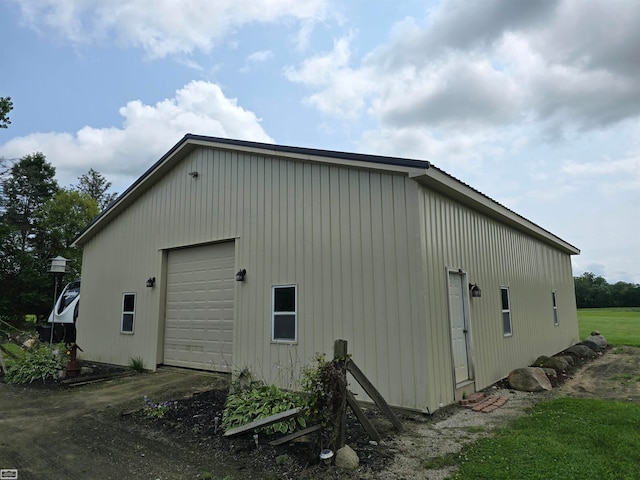 view of side of home with a garage and an outdoor structure