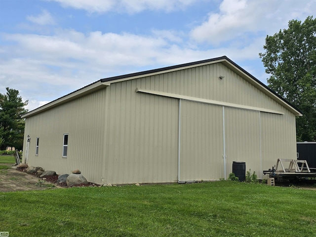 view of side of property with a yard and an outdoor structure