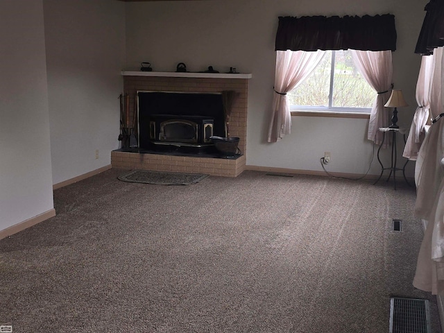 unfurnished living room with carpet and a wood stove