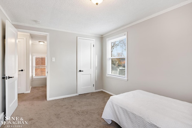 bedroom featuring a textured ceiling, light carpet, and ornamental molding