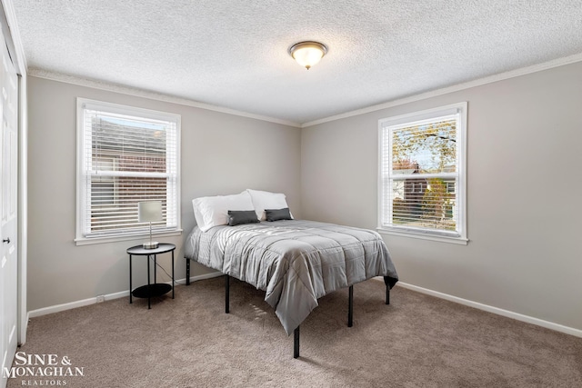 carpeted bedroom with a closet, a textured ceiling, and crown molding