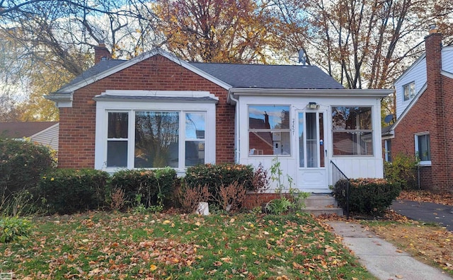 bungalow-style house featuring a sunroom